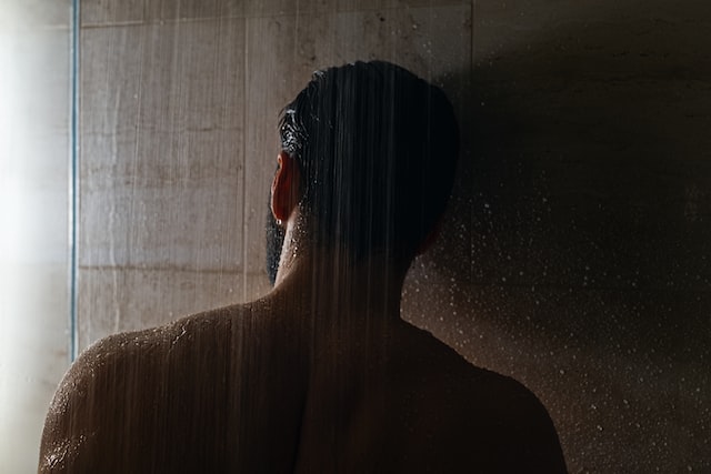 man washing in shower