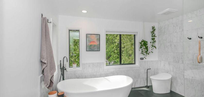 white bathtub near white bathtub